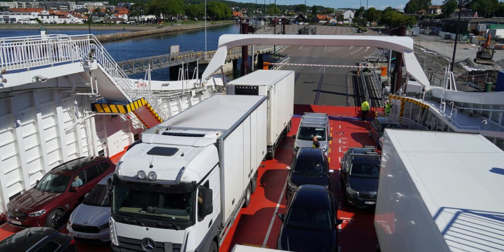 A selection of cars and lorries loading onto a ferry.