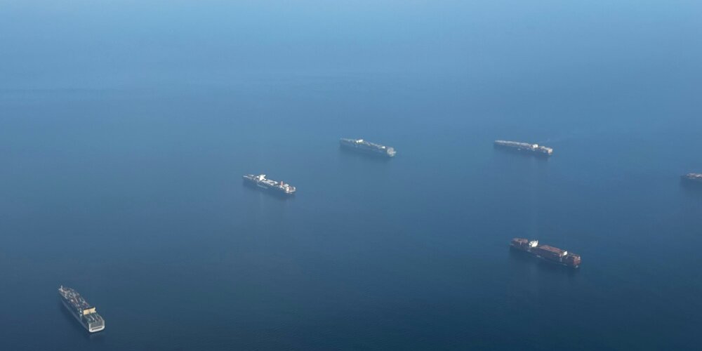 Five cargo ships sailing across the Panama Canal.